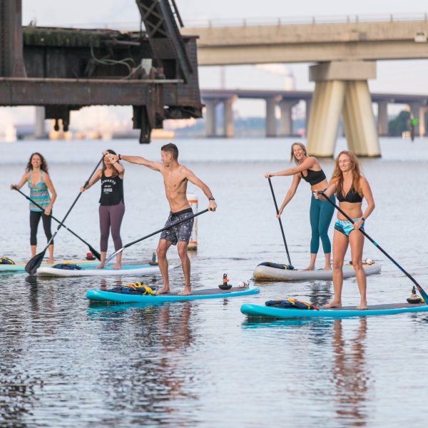 Group of people having fun on a paddle board