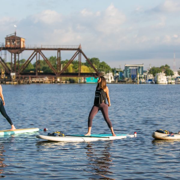 3 ladies doing stand up paddle board fitness class