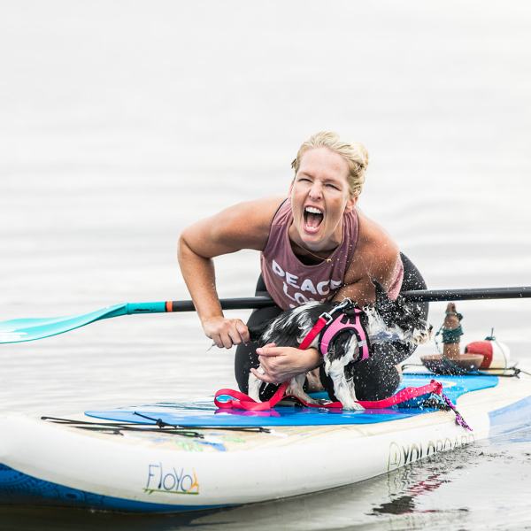 a man riding on the back of a boat in the water