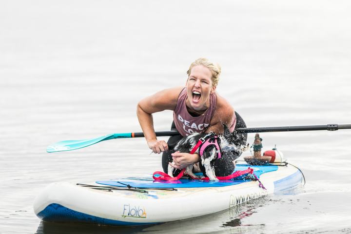 a man riding on the back of a boat in the water