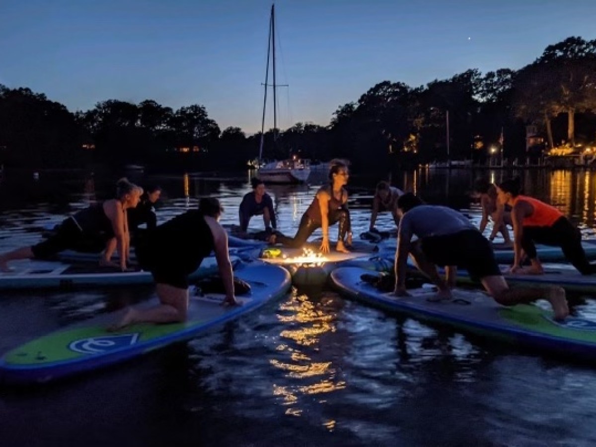 a group of people sitting in a boat on a body of water