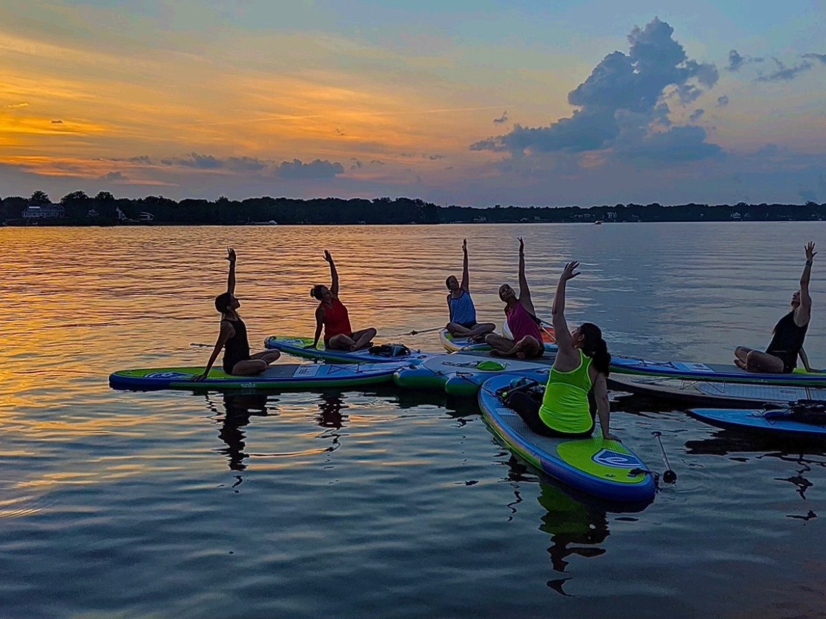 a group of people in a small boat in a body of water