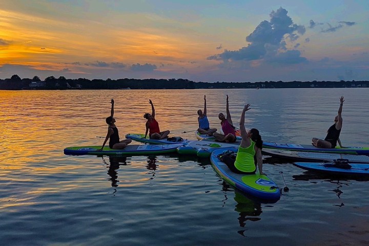 a group of people in a small boat in a body of water