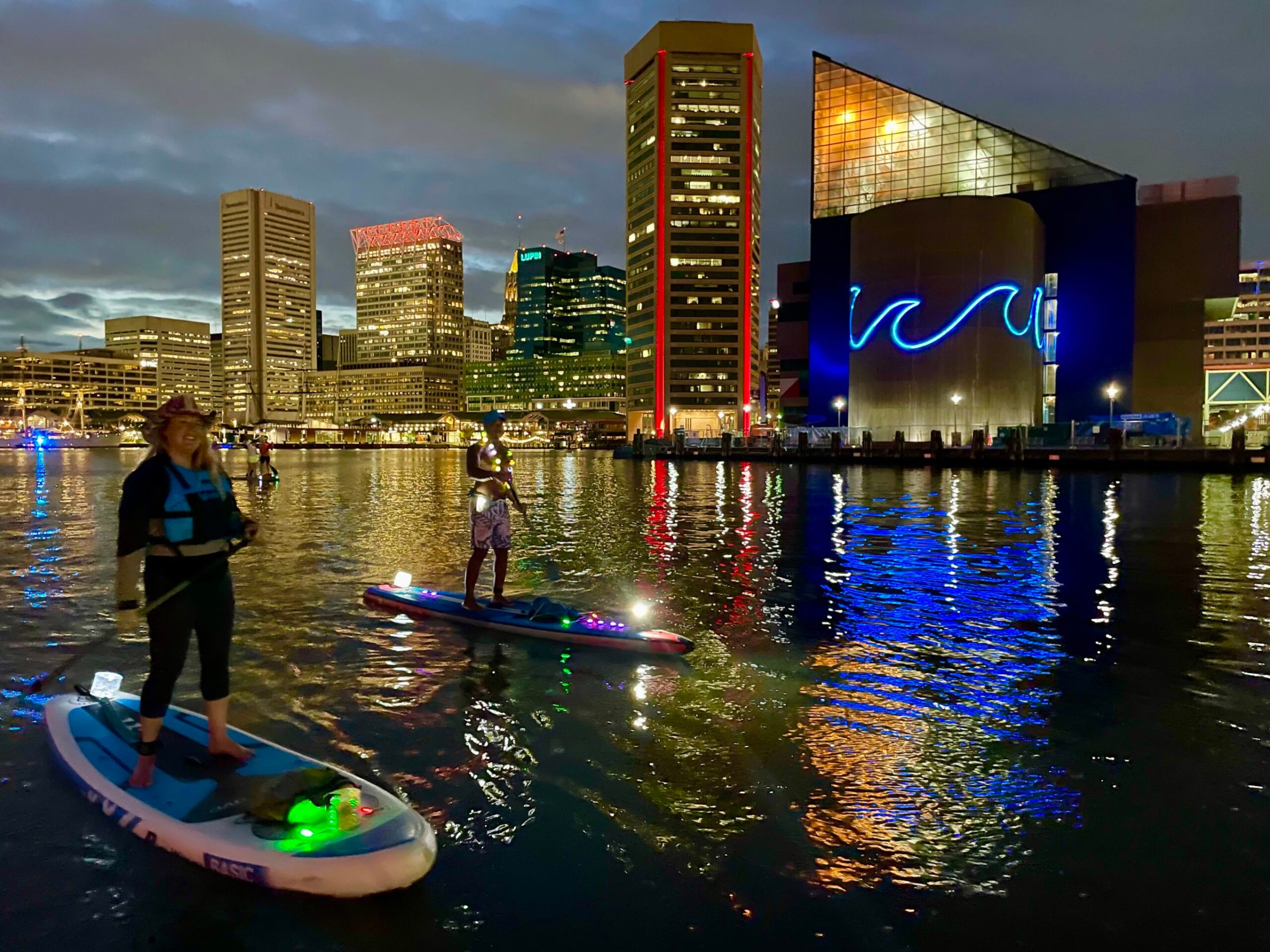 a group of people standing next to a body of water