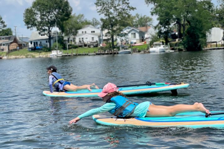 a group of people rowing a boat in the water