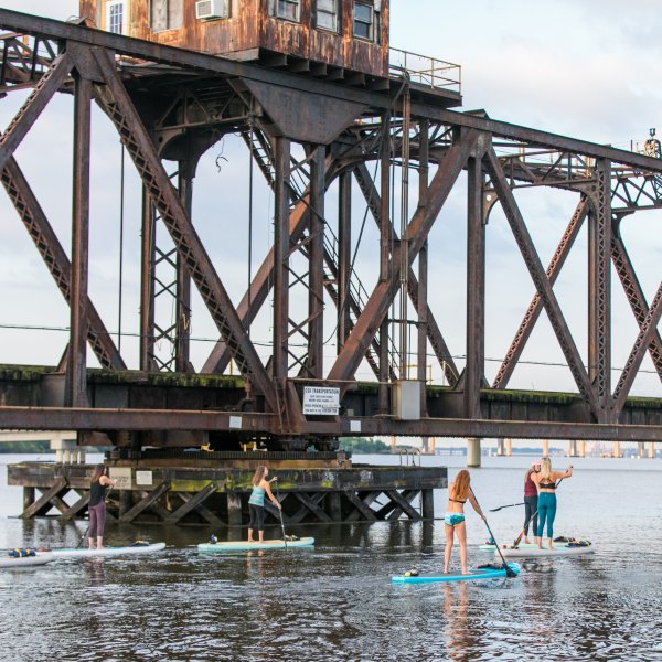 Group of people doing SUP in the river