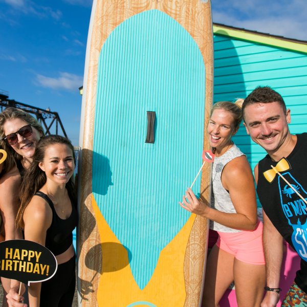 Paddle board instructors having a celebration