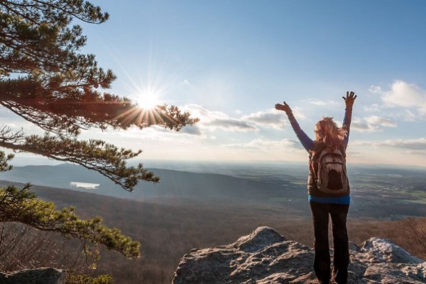 a person standing in front of a mountain