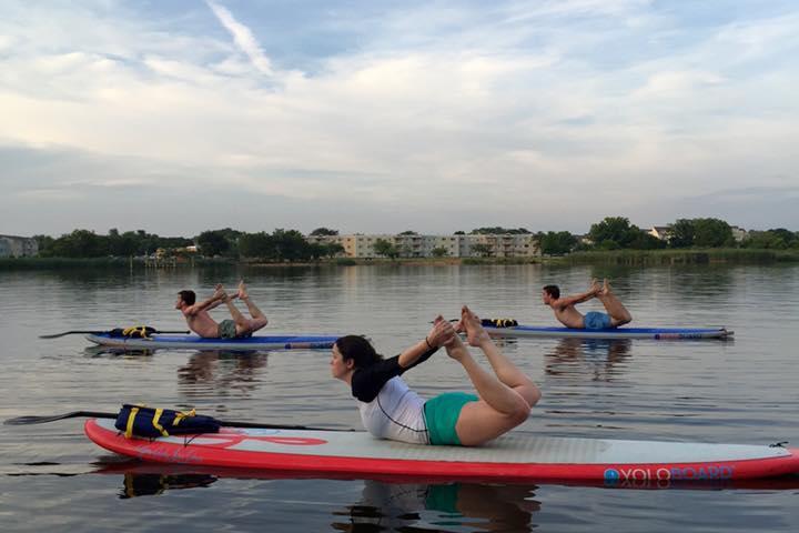 a group of people rowing a boat in a body of water