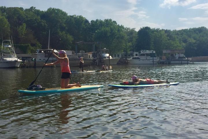 a group of people rowing a boat in the water