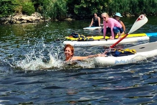 a girl riding a wave on a surf board on a body of water