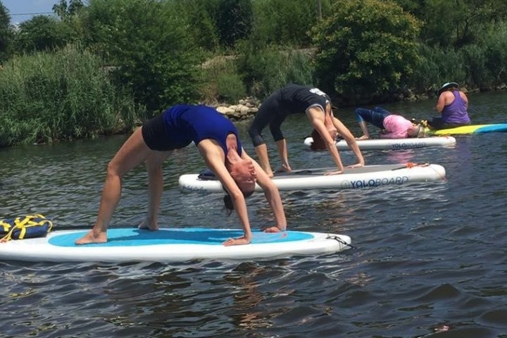 a girl riding a wave on a surf board on a body of water