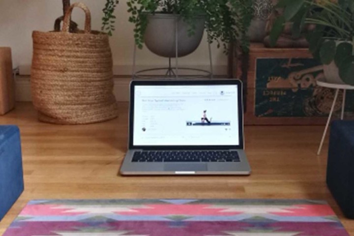 a laptop computer sitting on top of a wooden table