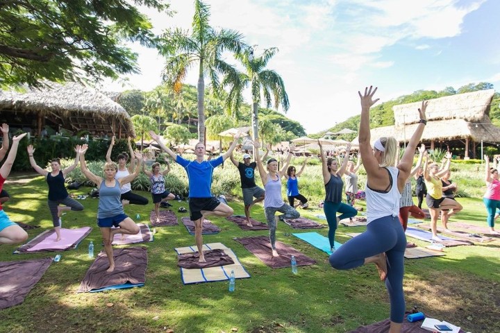 a group of people sitting in a yard