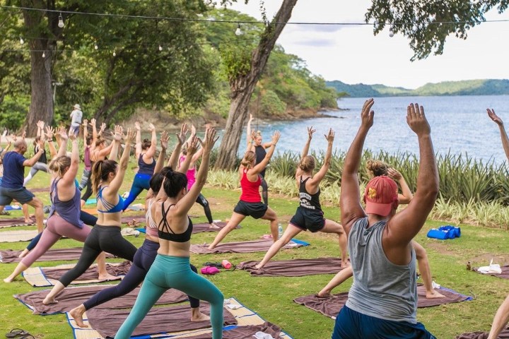 a group of people playing frisbee in a park