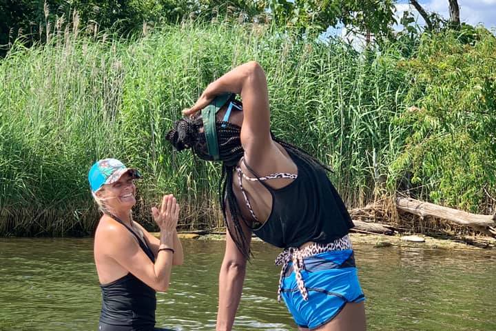 a group of people riding on the back of a boat in the water