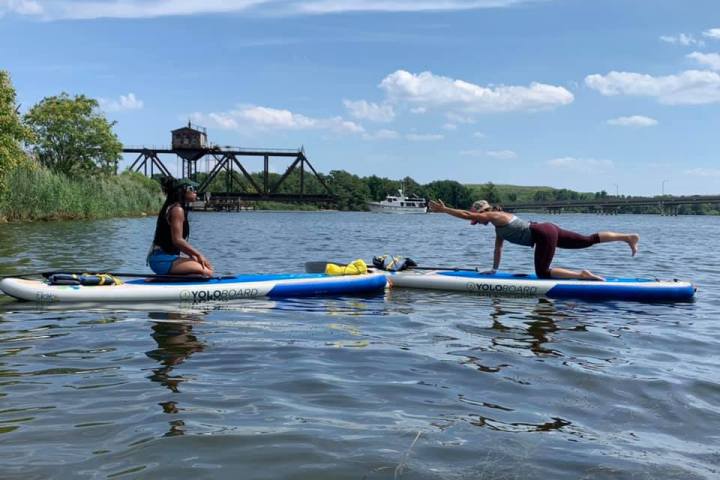 a group of people rowing a boat in the water