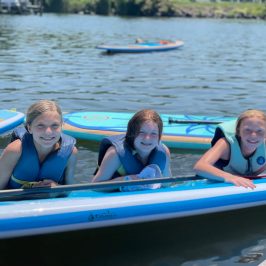 a group of people rowing a boat in a body of water