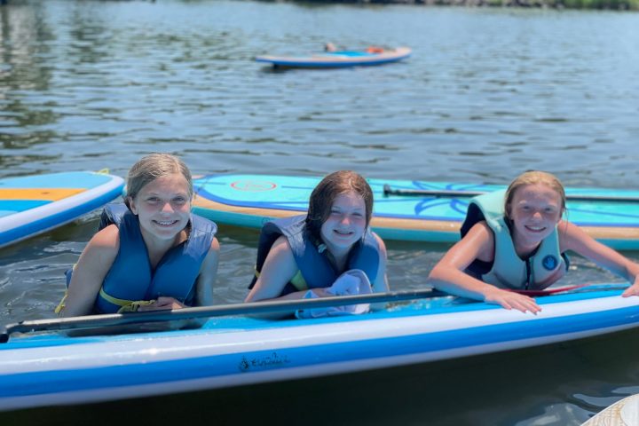 a group of people rowing a boat in a body of water
