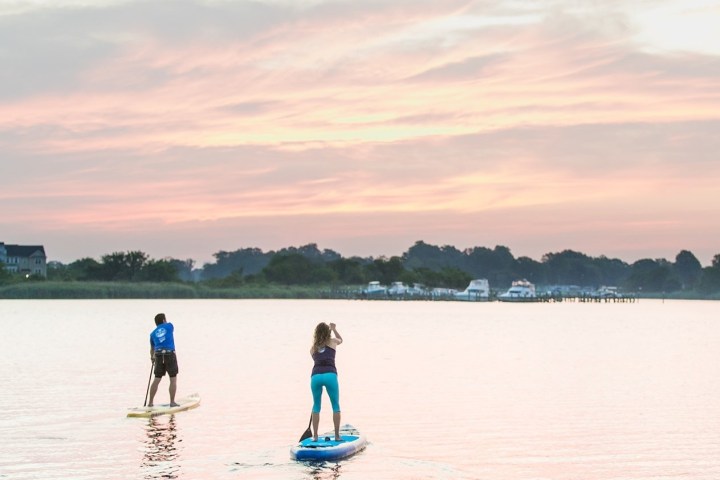 a person standing next to a body of water