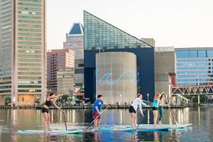 a group of people standing next to a body of water