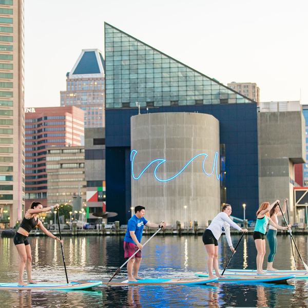 a group of people standing next to a body of water