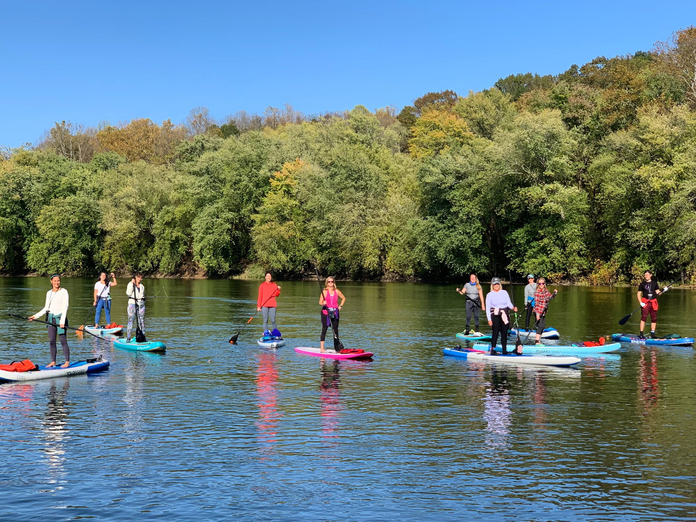 a group of people rowing a boat in the water
