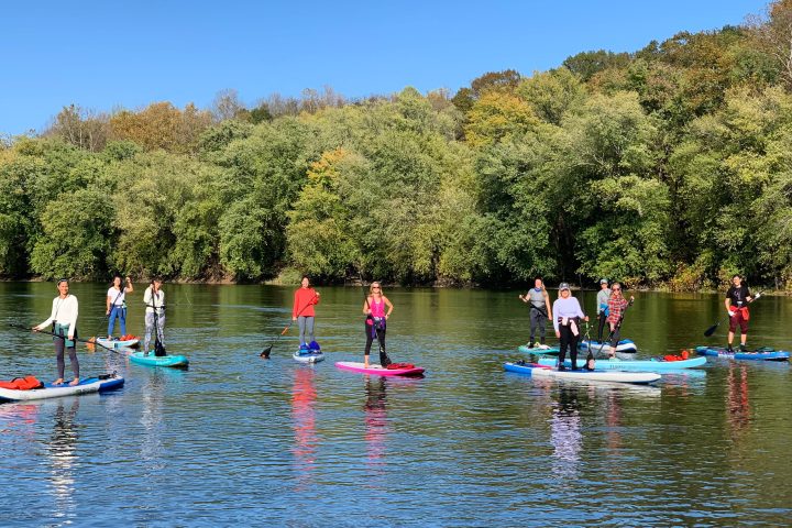 a group of people rowing a boat in the water