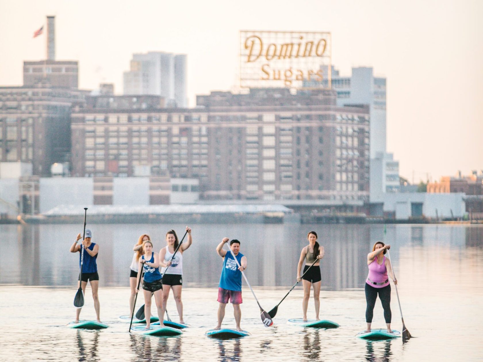 a group of people standing next to a body of water