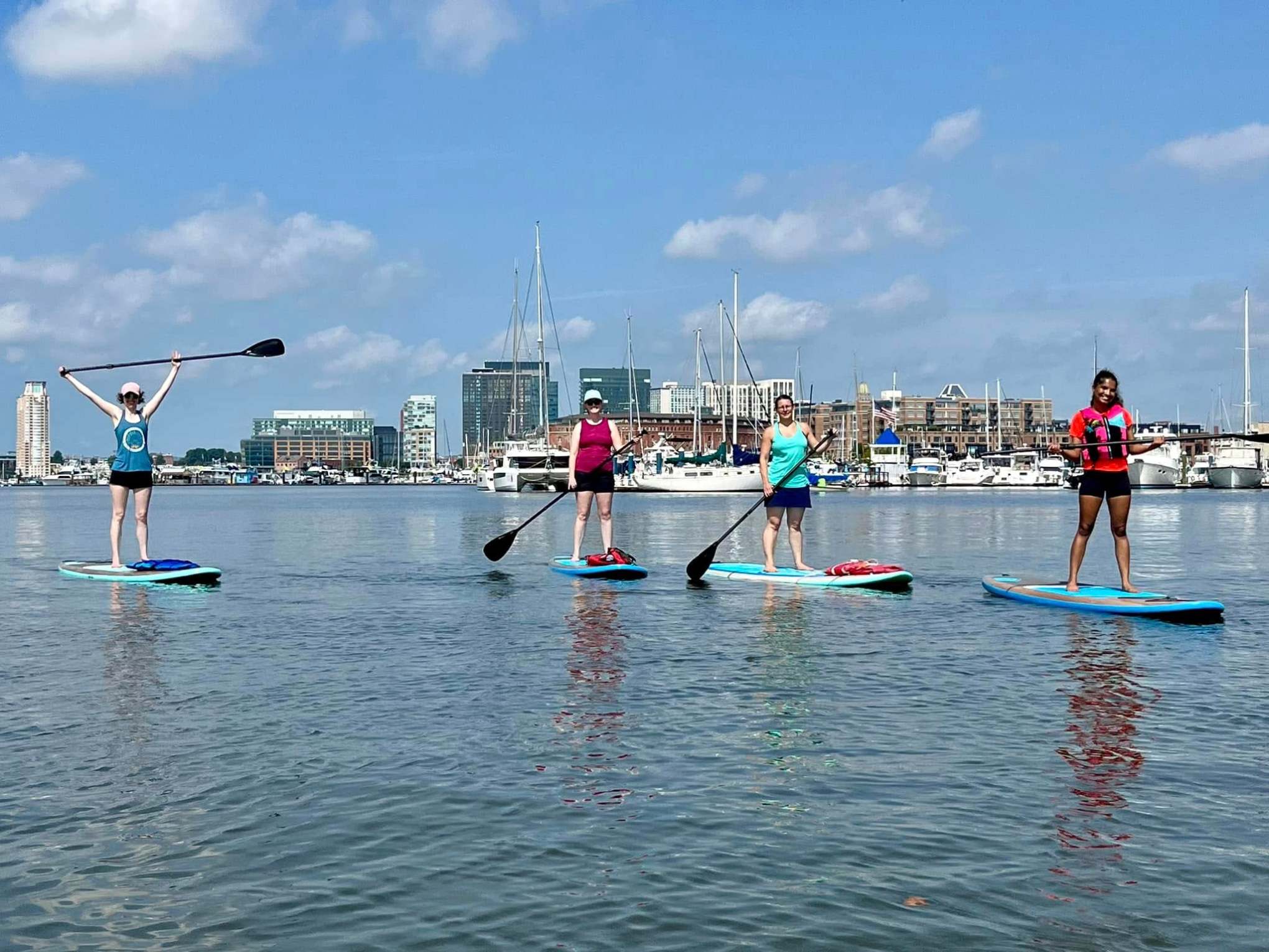 a group of people rowing a boat in the water