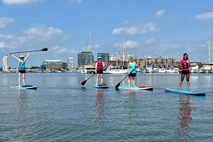 a group of people rowing a boat in the water