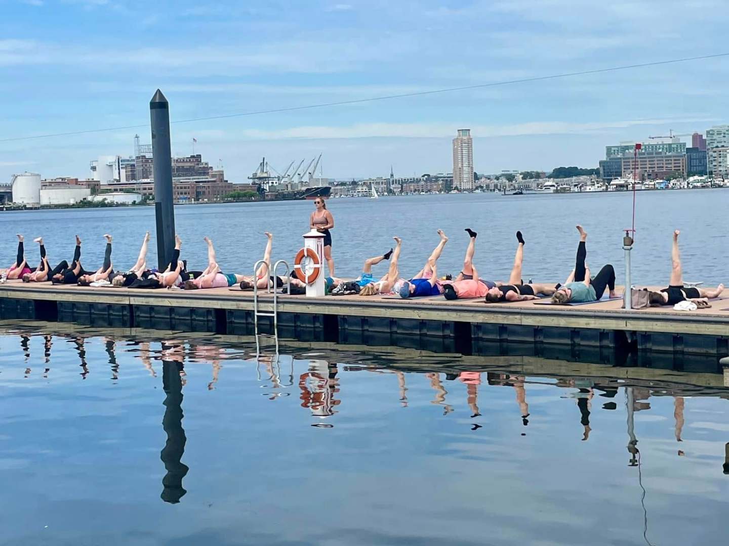 a group of people on a dock next to a body of water